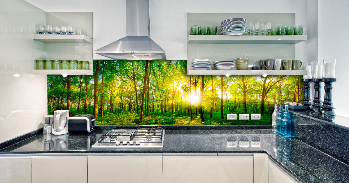 Küche mit Waldmotiv auf der Rückwand, umgeben von offenen Regalen und Küchengeräten.